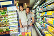 © Mediteraneo - Father and son doing grocery shopping at the supermarket