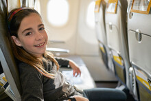 Caucasian Girl Passenger Sitting On Board A Commercial Flight