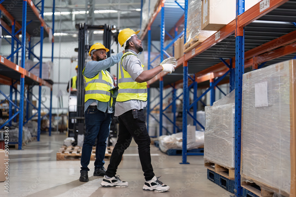 African american working in warehouse hold stock check list while truck ...