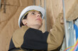 © auremar - female builder putting insulation wall