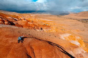 Tourist traveler on Altai landscape republic Russia. Red color sand and clay Mars Altay, Aerial drone view