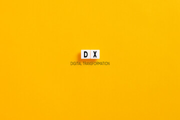 White letter blocks on yellow background with the acronym DX digital transformation.