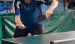 Table Tennis Player serving, holding ball in hand