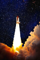 Wall Mural - shuttle launch in the clouds to outer space. dark space with stars on background.spaceship flight. e