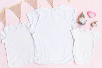 Wall Mural - Easter mom and kids mockup white t-shirt and baby bodysuit onesie with gnomes and heart on pink cover background. Flatlay, top view, copyspace.