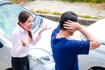 Angry Asian woman The car was involved in an accident on the road. Quarrel with the other party. Transportation concept. car insurance