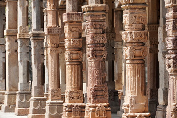 Wall Mural - Row of pillars with bas relief carvings in the complex of Qutb Minar, Delhi. Architectural columns with beautiful relief carvings.