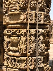 Wall Mural - Pillars with beautiful carvings at the complex of Qutb Minar, Delhi. Architectural columns with beautiful relief carvings.