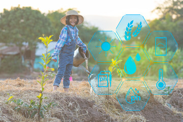 Smart farm for rural agriculture on kid watering the tree in garden