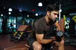 © offsuperphoto - young sports man lifting dumbbell in the gym