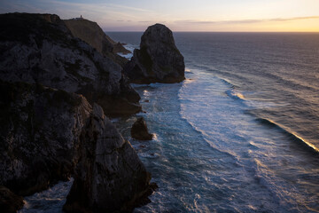 Wall Mural - View of the cliffs of Cabo da Roca and the ocean surf at sunset in Sintra, Portugal.