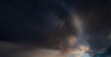 Wall Mural - Beautiful long exposure night sky with clouds and stars . Starry sky background.