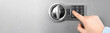 Man opening steel safe with electronic combination lock, closeup. Banner design