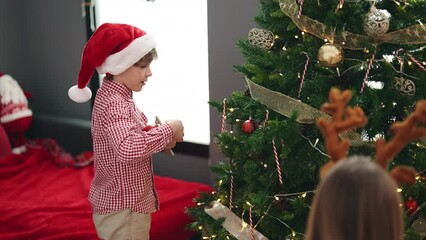 Sticker - Brother and sister decorating christmas tree at home