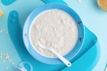 Wall Mural - Baby plate with porridge on blue