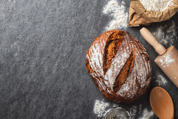 Poster - Whole loaf of fresh homemade bread on the table in the bakery top view