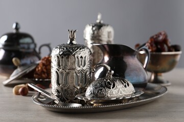 Wall Mural - Tea, date fruits and Turkish delight served in vintage tea set on wooden table