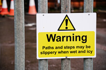Slippery When Wet And Icy Warning Sign At Entrance To Building Site