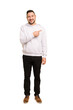 © Asier - Full body adult latin man cut out isolated smiling and pointing aside, showing something at blank space.