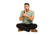 © Asier - Adult latin man sitting on the floor cut out isolated saying a gossip, pointing to side reporting something.