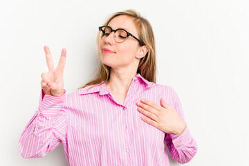 Wall Mural - Young caucasian woman isolated on white background taking an oath, putting hand on chest.