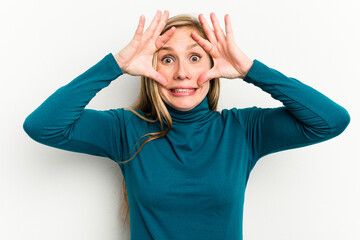 Wall Mural - Young caucasian woman isolated on white background keeping eyes opened to find a success opportunity.