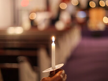 A Black  African-American Woman Holding A Candle In Her Hand