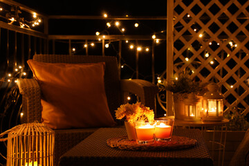 Canvas Print - Beautiful view of garden furniture with pillow and burning candles at balcony