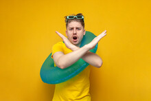 Guy With An Inflatable Swimming Ring On Vacation In The Summer Does Not Allow With His Hands And Shows A Stop