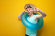 © Богдан Маліцький - young guy in the summer on vacation with sunglasses and a swimming inflatable ring shows gesture of peace