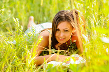 Young Woman In Green Dress Rest In The Grass