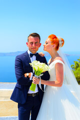 Wall Mural - Beautiful young couple bride and groom celebrate wedding on Santorini