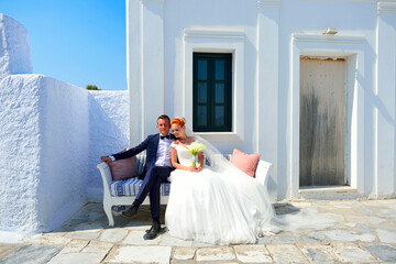 Wall Mural - Beautiful young couple bride and groom celebrate wedding on Santorini