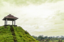 A Lone Pavilion On The Top Of A Hill, With Some Bulls Sculpture On The Of It