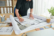 © DragonImages - Cropped image of interior designer creating project of kitchen for client