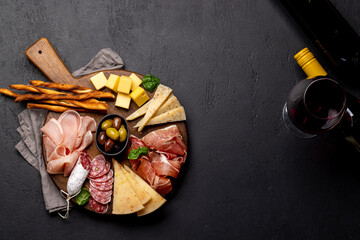 Wall Mural - Antipasto board with various meat and cheese snacks