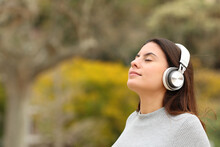 Teen Breathing With Headphones Meditating In A Park