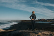 © Westend61 - Woman standing with hands on hip at Janubio Beach, Lanzarote, Canary Islands, Spain