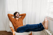 © Westend61 - Happy young man with eyes closed relaxing in armchair