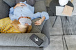 © Westend61 - Woman wearing eye mask sleeping on sofa with smart phone at flight mode