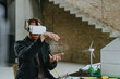 © Westend61 - Architect wearing VR simulator gesturing with wind turbine design at construction site