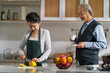 happy asian old couple talking chatting in kitchen
