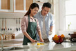 © imtmphoto - young asian couple talking chatting in kitchen