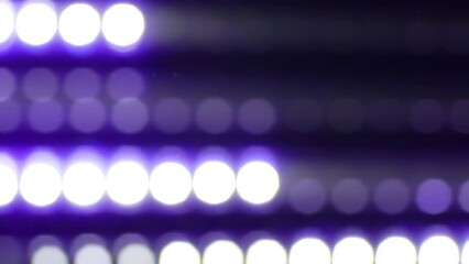 Wall Mural - Purple Dotted lines motion with depth of field effect. Defocused bokeh lines moving horizontally. Glowing bokeh circles with trail moving across the frame. Abstract led light disco wall. 4K Loop.