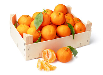 Wall Mural - Orange tangerines with green leaves in a box. Tangerine is divided in half and into pieces. isolated on white background