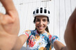© VISTA by Westend61 - Happy cyclist taking selfie in front of wall