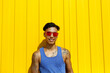 © VISTA by Westend61 - Smiling man wearing red sunglasses leaning at yellow wall