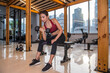 © Cavan Images - Woman exercising with dumbbell in gym