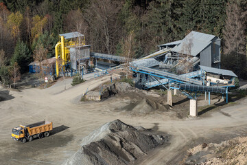 Truck and mining equipment in the quarry. Industrial stone quarrying.