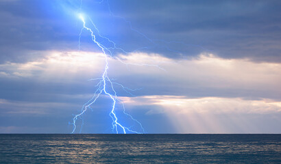 Poster - Beautiful landscape with lightning over the calm sea at sunset 